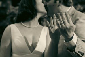 Close-up of a couple's hands showing their wedding rings